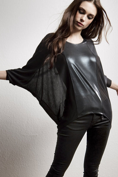 NORDENFELDT Nude Vic Shiny, triangle top in black with shiny application at front part, with 3/4 sleeves and longer back hemline, loose fit, worn by Tarja Turunen